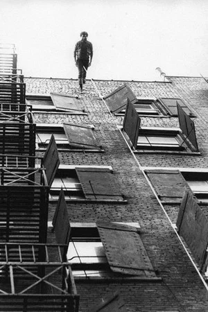 Постер: Man Walking Down the Side of a Building